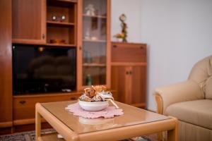 a living room with a table with a bowl of food on it at Apartment in Mundanije with Seaview, Terrace, Air condition, WIFI (3748-1) in Mundanije