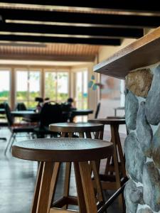 a row of tables and stools in a restaurant at Resort Yxenhaga in Hok