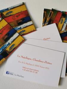 two envelopes with a piece of art on them at La Majolique in Namur