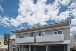 a building with a cloudy sky in the background at Corner45 Apartments in Kalamaki