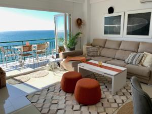 een woonkamer met een bank en uitzicht op de oceaan bij Beachfront apartment in Fuengirola in Fuengirola