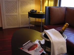 a bottle of wine on a table in a room at Colosseo Studio Suite in Rome