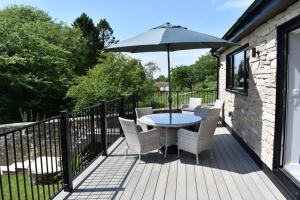 a patio with a table and chairs and an umbrella at The View in Shaftesbury