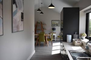 a kitchen and dining room with a table and chairs at The View in Shaftesbury