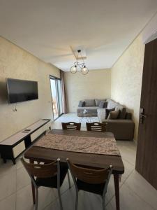 a living room with a table and a couch at APPART SMIR PARK in Tetouan
