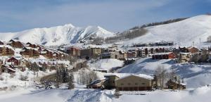 a town covered in snow with a mountain in the background at Elevation Hotel & Spa in Crested Butte