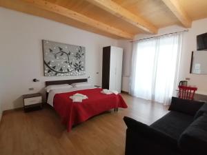 a bedroom with a bed with a red blanket at the Mainstreet in Agerola