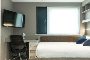 a bedroom with a bed and a desk and a tv at For Students Only - Premium Accommodation at Eclipse Student Accommodation in Cardiff in Cardiff