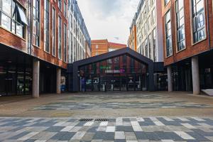 an empty street in a city with tall buildings at For Students Only Collegiate Eclipse Cardiff in Cardiff