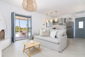 a living room with a couch and a table at Isalos Villas with private pool in Naxos Chora
