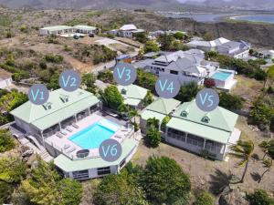 an aerial view of a house with synergy logos on it at V3 Magical view on the heights of Oyster Pond in Oyster Pond