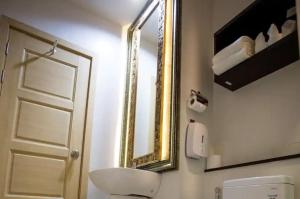a bathroom with a sink and a mirror and a toilet at Zotel in Chiang Mai +25 photos