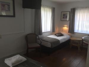 Un pat sau paturi într-o cameră la Hotel Heijenrath