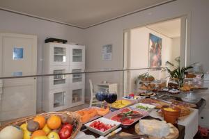 a table with a bunch of food on it at Relais Villa Isabel in Pietrasanta