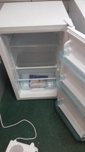 an open refrigerator with a drawer filled with books at KINGDOM HOLIDAY PARK - Parrot in Millom