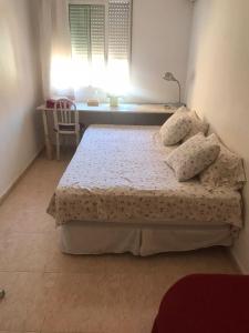 1 dormitorio con 1 cama, escritorio y ventana en el valle, en Murcia