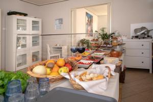 a kitchen with a table with a basket of fruits and vegetables at Relais Villa Isabel in Pietrasanta