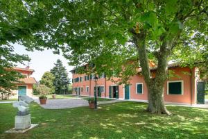 a building with a tree in front of it at Relais Villa Isabel in Pietrasanta