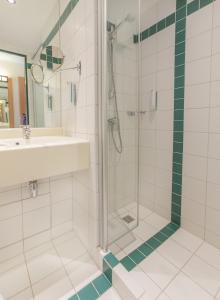 a bathroom with a shower and a sink at Essential by Dorint Remscheid in Remscheid