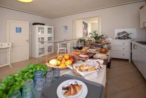 a kitchen with a table with a bunch of food on it at Relais Villa Isabel in Pietrasanta