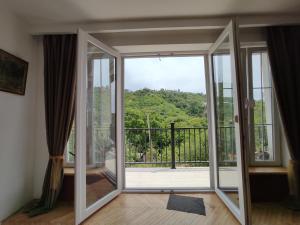 a room with an open door to a balcony at The nature in Sighnaghi