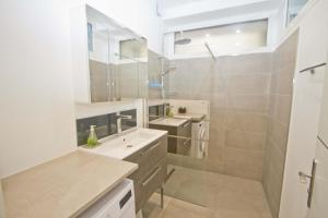 a white bathroom with a sink and a shower at Florida Sea Front in Nice +19 photos