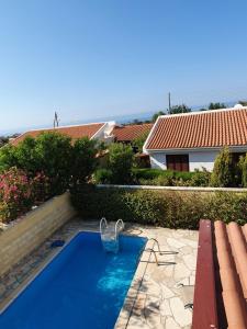 a swimming pool in the backyard of a house at Melanta Villa in Pissouri