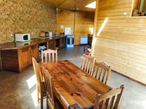 a wooden table and chairs in a kitchen at Agroturystyka Jeleni Skok in Cisna