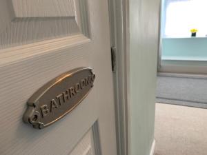 a doorhandle to a door with a sign on it at Evangelisa in Lampeter