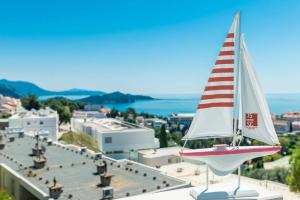 a small sail boat sitting on top of a building at Apartment Eulalija in Dubrovnik