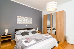 a bedroom with two beds and a mirror at Apartment Eulalija in Dubrovnik