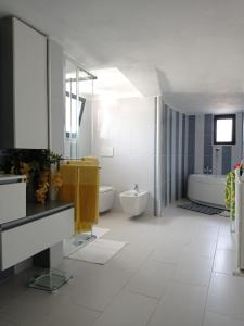 a bathroom with a tub and a toilet and a sink at Marina Piccola Apartment in Bari