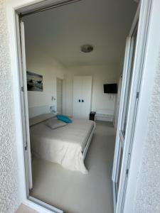 a bedroom with a bed in a white room at Gassa d amante in Stintino