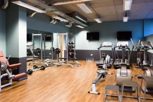 a gym with several treadmills and exercise equipment at Premium Studios and Apartments at Chapter Portobello in London in London