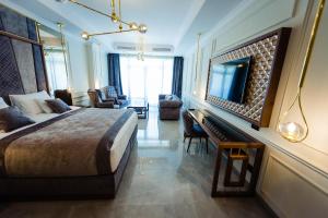 a hotel room with a bed and a television at Vila 6 Neptun Olimp in Olimp +34 photos