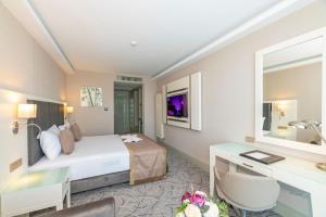 A bed or beds in a room at The Conforium Hotel Van