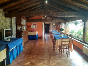 a long dining room with blue tables and chairs at La Casona de Barrio in Barrio