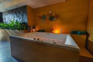 a large bath tub in a room with wood at Apartmán Lux in Bojnice