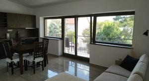 a kitchen and living room with a table and a couch at LAVENDER APARTMENT in Balatonboglár