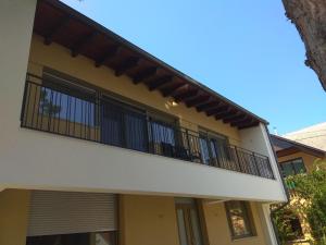 a balcony of a house with black railing at LAVENDER APARTMENT in Balatonboglár