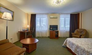 a hotel room with a bed and a television at Hotel Forum in Magnitogorsk
