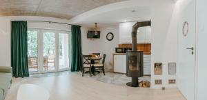 a living room with a kitchen and a dining room at Hej na Mazury Apartamenty in Ruciane-Nida