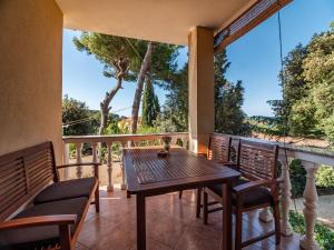 a patio with a wooden table and chairs on a balcony at Villa Emilia in Banjole