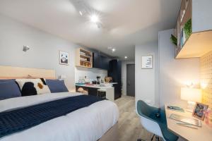 a bedroom with a king sized bed and a desk at Sleek Studios, Apartments and Private Bedrooms at Silk Mill close to Edinburgh Old Town in Edinburgh