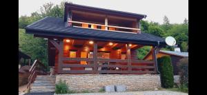 a house with a black roof and a building at Chata Kriváň - bez kontaktu s ubytovateľom "Click 'n Sleep" in Terchová