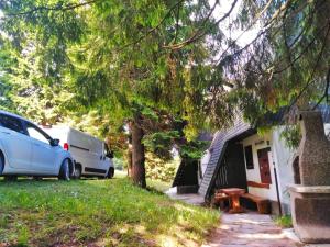 a van parked in front of a house with a caravan at Rogla Apartma Gaber54 in Zreče