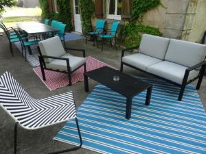 a patio with chairs and a table and a couch at LA BELLE D'ANTAN in Saint-Bonnet-en-Bresse +7 photos