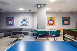 a room with a ping pong table and paintings on the wall at Stunning Apartments at Dashwood Studios in London in London