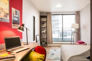 a bedroom with a desk with a laptop computer on it at Stunning Apartments at Dashwood Studios in London in London