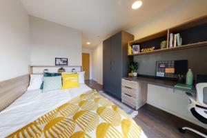 a bedroom with a large bed and a desk at Private Bedrooms with Shared Kitchen, Studios and Apartments at Canvas Glasgow near the City Centre for Students Only in Glasgow